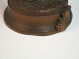 a bronze statue of a cat sitting on top of a box