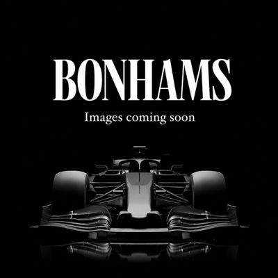 a black and white photo of a racing car with the words bonhams