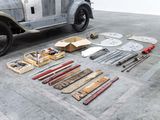 a car that is sitting in a garage with tools