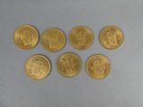 six souverains d'or de tailles et de formes différentes
