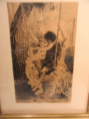 framed picture of a boy on a swing in a wooded area