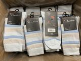 six pairs of men ' s socks in a box with tags