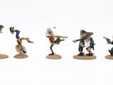 five figurines of people with guns on a white surface