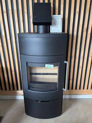 a black stove sitting in the corner of a room