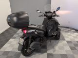 a motorcycle that is parked in a room with a checkered floor