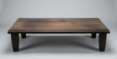 a wooden coffee table with a thick top and dark wood legs