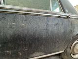 a black car that is parked on the side of the road