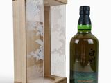 an empty bottle of whisky sitting next to a wooden box