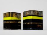 two black and yellow cubes sitting on top of each other
