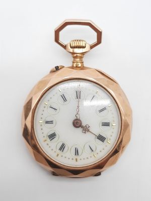 une montre de poche en or avec des chiffres romains sur le cadran