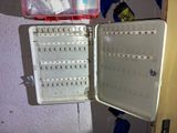an open plastic box with a lot of medicine in it