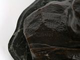 a close up of a statue of a dog on a rock