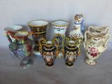 a lot of vases that are sitting on a table