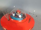 a small toy in the shape of a flying saucer