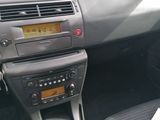 a car dashboard with a steering control and a paper in it