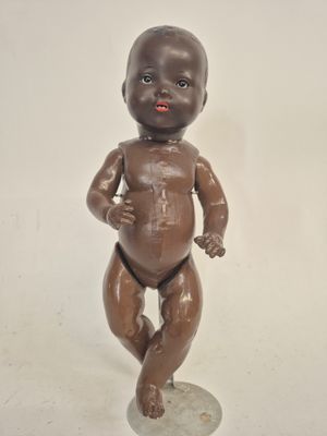 a statue of a baby that is standing on a pedestal