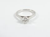 a close up of a diamond ring on a white surface