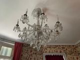 a crystal chandelier hanging from the ceiling in a room