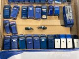 a lot of blue toy cars in a cardboard box