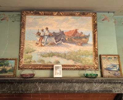 a picture of a painting on the wall above a fireplace