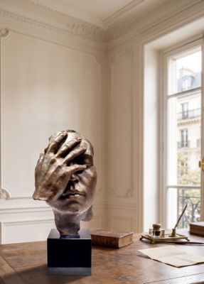 a sculpture on a table in a room with a window