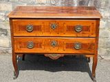 a wooden chest of drawers with brass pulls on the drawers