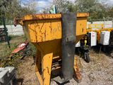 a yellow dumpster sitting in the middle of a field