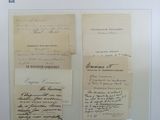 several old papers are hanging on a wall in a room