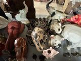 many different types of ceramic animals on the table