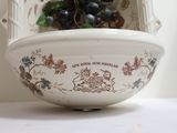 a white bowl with a bunch of grapes in it