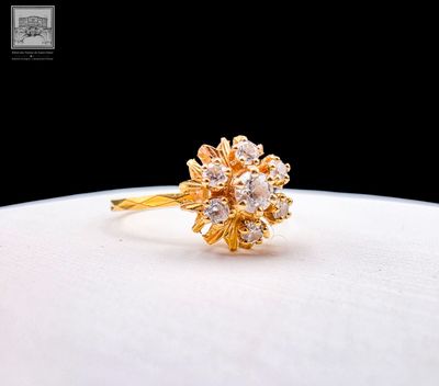 an image of a gold ring with diamonds on a white surface