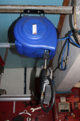 a picture of a water heater and a hose in a room