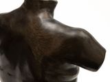 statue of a male torso on a marble base against a white background