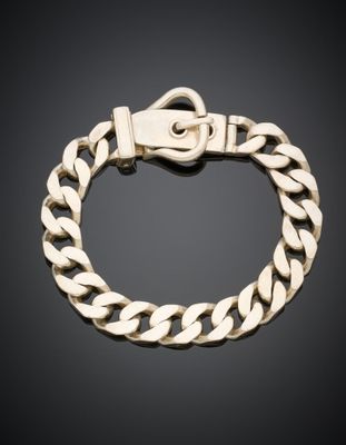 un bracelet en or muni d'un fermoir, sur fond noir