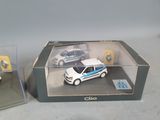 two toy cars in a display case on a table