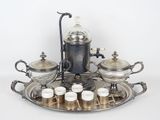 un plateau en argent sur lequel sont posées des tasses et des soucoupes