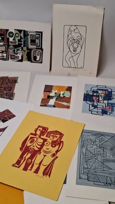 many different types of art work displayed on a table