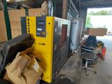 a yellow machine that is sitting in a garage