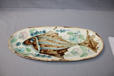 a plate with a fish design on it on a table