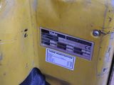 a close up of a yellow gas tank with a sticker on it