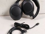 a close up of a pair of headphones on a table next to a usb cable
