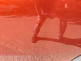 a man that is standing in the street with a skateboard