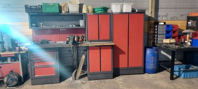 a red cabinet in a garage with many other tools