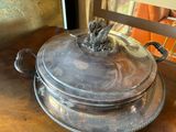 a silver plate with a bird on it sitting on a table