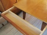 a wooden table with a drawer on top of it