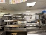 a large commercial kitchen with stainless steel appliances and counters