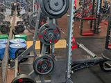 a gym with a lot of equipment in the room