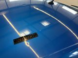 a sticker on the hood of a blue car