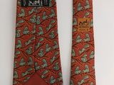 two neck ties with different designs on them on a white surface