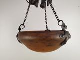 an image of a wooden bowl hanging from a chain